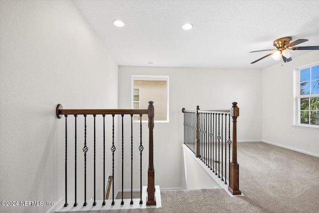 stairs with a textured ceiling, recessed lighting, carpet, and baseboards