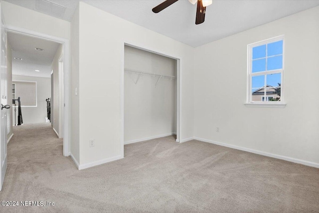 unfurnished bedroom with carpet floors, a closet, and baseboards