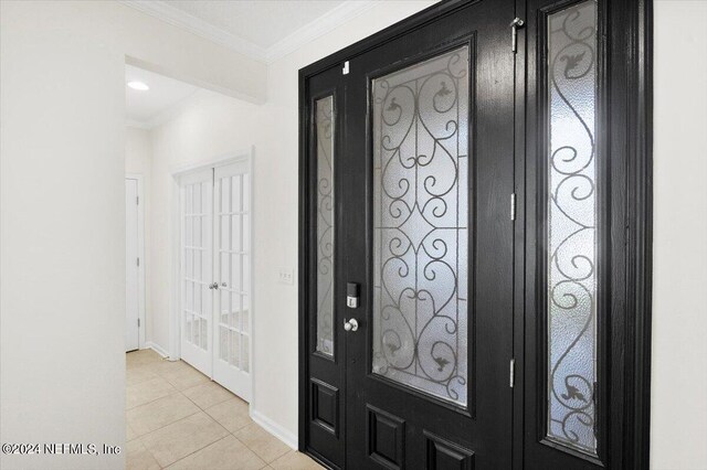 tiled foyer entrance with ornamental molding