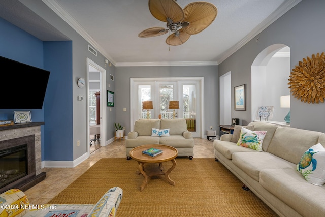 living room featuring ceiling fan, light tile patterned floors, and crown molding