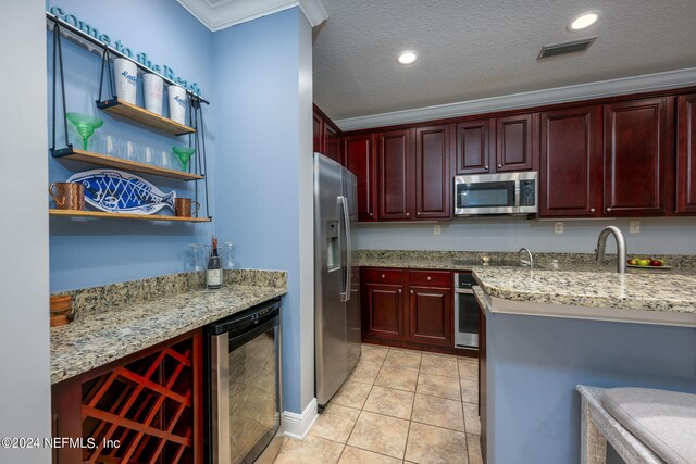 kitchen featuring crown molding, beverage cooler, stainless steel appliances, and light stone counters