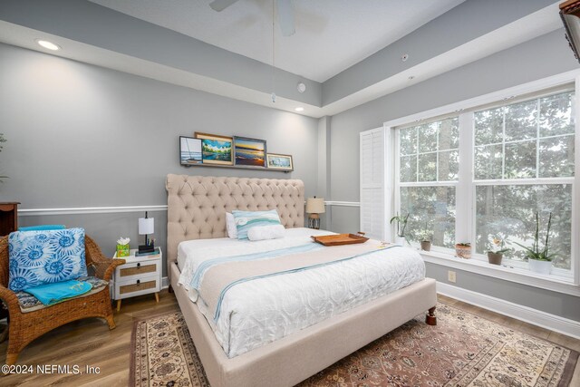 bedroom with wood-type flooring and ceiling fan