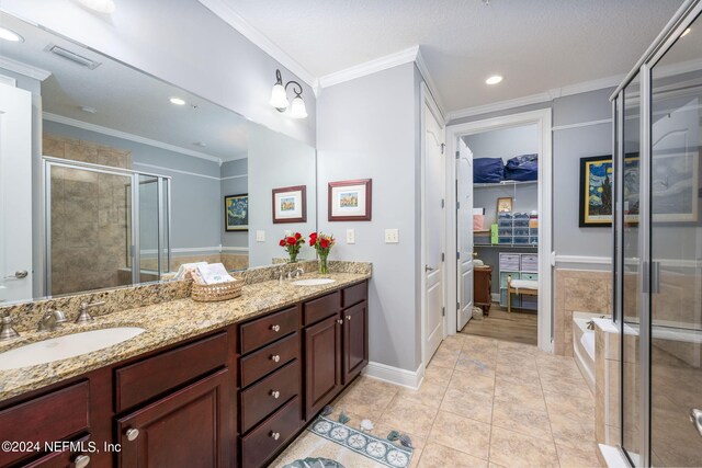 bathroom with vanity, a textured ceiling, crown molding, separate shower and tub, and tile patterned floors