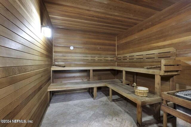 view of sauna / steam room featuring wooden walls and wood ceiling