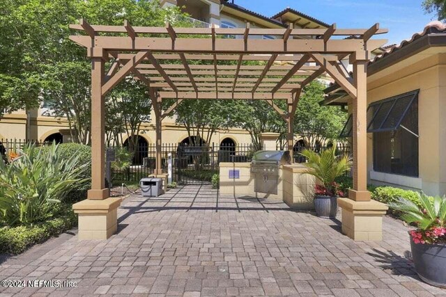 view of patio with a pergola and a grill