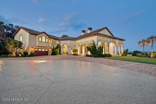 mediterranean / spanish home featuring a garage