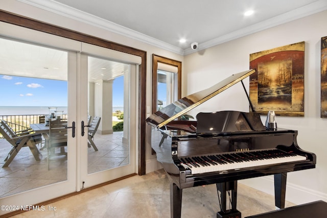 misc room with ornamental molding and a water view