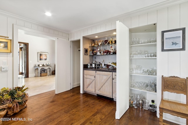 bar featuring crown molding and dark wood-type flooring