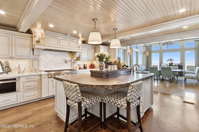 901 Ponte Vedra Blvd, Ponte Vedra Beach, FL 32082 - kitchen featuring a breakfast bar, wooden ceiling, stainless steel appliances, and backsplash