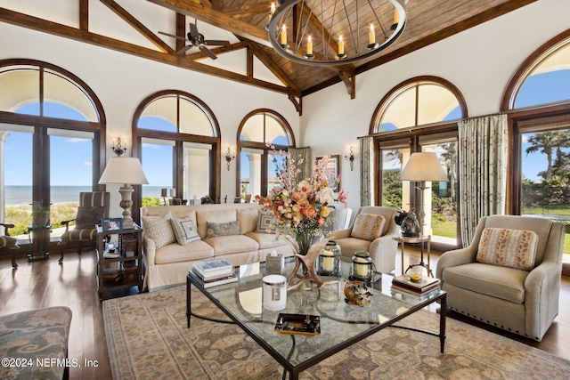 living room featuring beamed ceiling, wood ceiling, high vaulted ceiling, hardwood / wood-style floors, and a water view