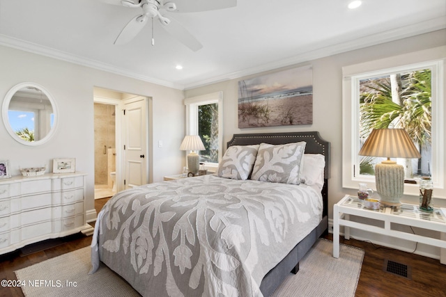 bedroom featuring multiple windows, ensuite bath, ceiling fan, and dark wood-type flooring