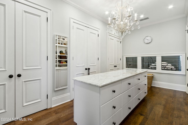 walk in closet featuring an inviting chandelier and dark hardwood / wood-style floors