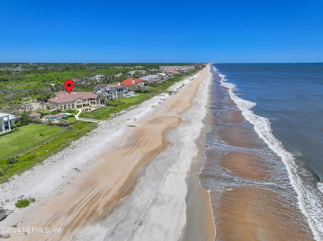 drone / aerial view with a water view and a view of the beach