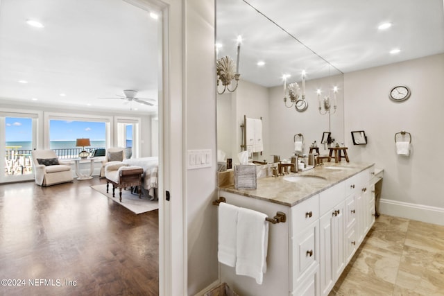 bathroom with wood-type flooring, vanity, and ceiling fan