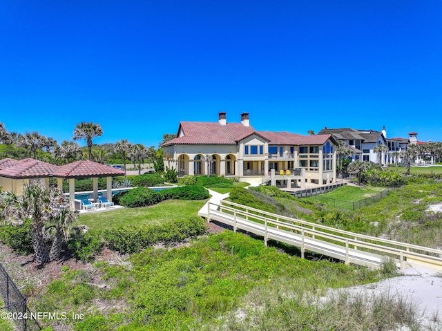 901 Ponte Vedra Blvd, Ponte Vedra Beach, FL 32082 - back of house with a tile roof, a yard, a fenced backyard, a chimney, and a gazebo