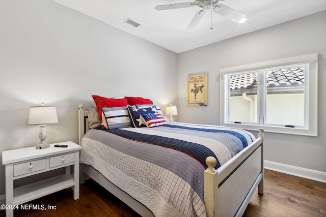 bedroom with ceiling fan and dark hardwood / wood-style floors