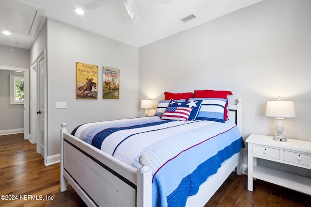 bedroom with dark hardwood / wood-style floors and ceiling fan