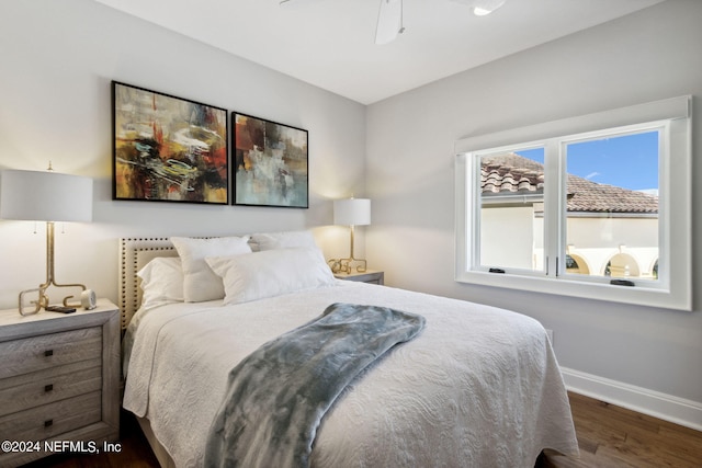 bedroom with dark hardwood / wood-style flooring and ceiling fan