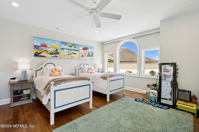 bedroom with ceiling fan and dark hardwood / wood-style flooring