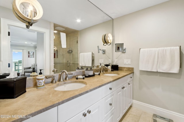 bathroom featuring vanity, a shower with shower door, and tile patterned flooring