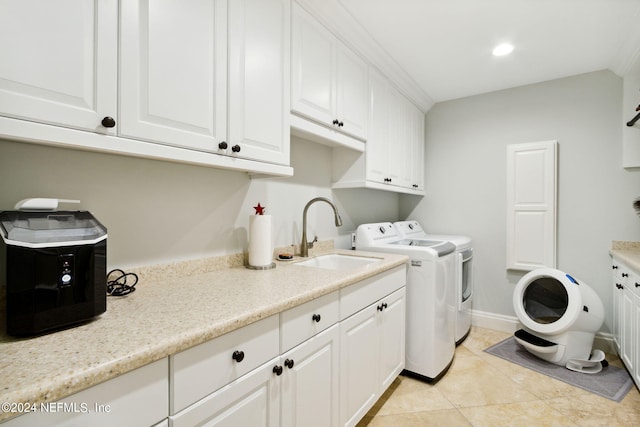 laundry room with washer and clothes dryer, cabinets, sink, and light tile patterned flooring