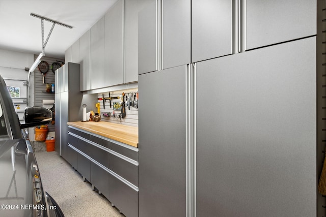 901 Ponte Vedra Blvd, Ponte Vedra Beach, FL 32082 - kitchen with light speckled floor, wooden counters, modern cabinets, and gray cabinets