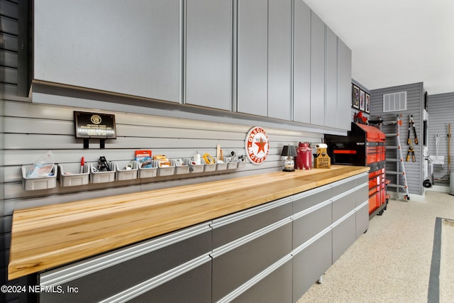 interior space with gray cabinetry and butcher block countertops