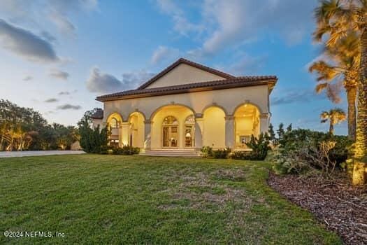 rear view of house with a yard