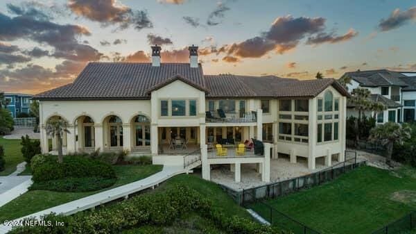 901 Ponte Vedra Blvd, Ponte Vedra Beach, FL 32082 - rear view of property featuring a patio, a balcony, a lawn, a tiled roof, and a chimney