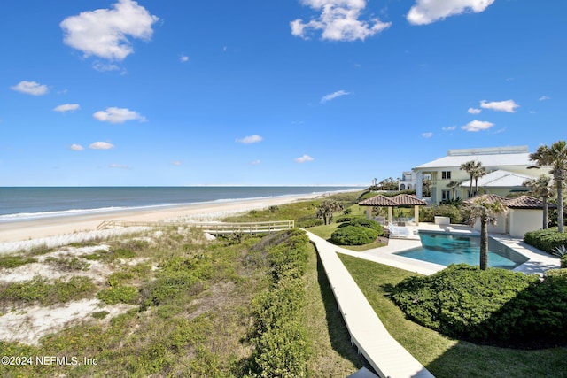 water view with a gazebo and a beach view