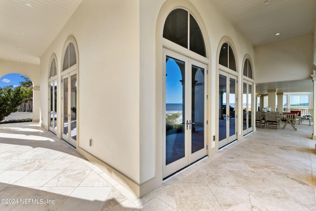 hall with french doors and a water view