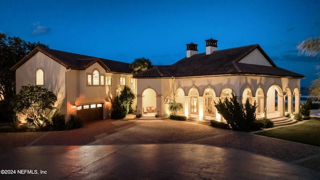 901 Ponte Vedra Blvd, Ponte Vedra Beach, FL 32082 - mediterranean / spanish house with stucco siding, decorative driveway, a chimney, and a garage