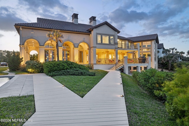 901 Ponte Vedra Blvd, Ponte Vedra Beach, FL 32082 - rear view of property featuring a balcony, a yard, a tiled roof, a chimney, and stucco siding