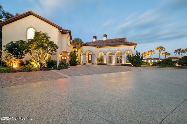 901 Ponte Vedra Blvd, Ponte Vedra Beach, FL 32082 - mediterranean / spanish-style home with a tiled roof, stucco siding, curved driveway, and a chimney