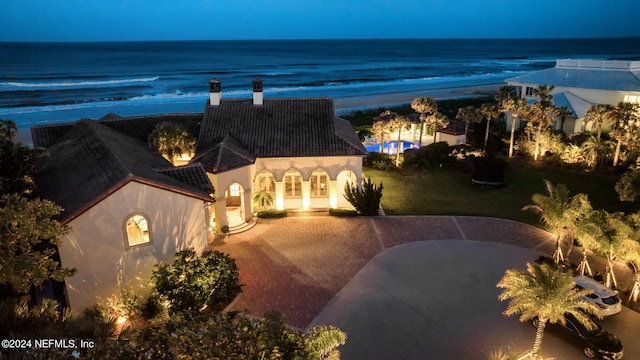 drone / aerial view featuring a beach view and a water view