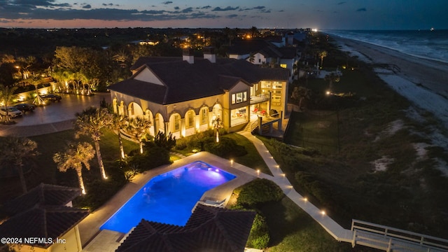 pool at dusk with a jacuzzi