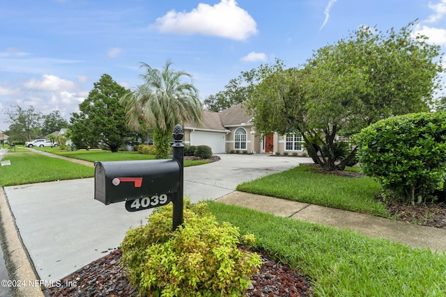 view of front facade with a front yard and a garage