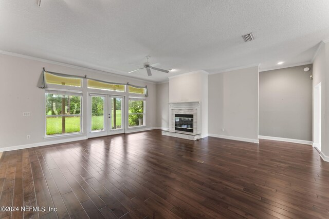 unfurnished living room with a premium fireplace, ceiling fan, dark hardwood / wood-style floors, and a textured ceiling