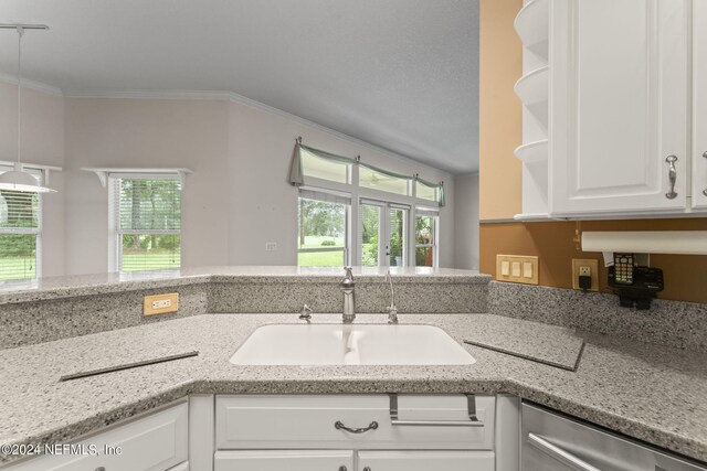 kitchen with sink, white cabinetry, decorative light fixtures, ornamental molding, and stainless steel dishwasher