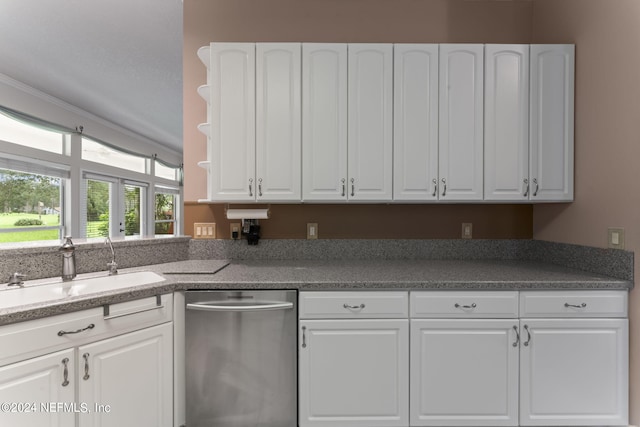 kitchen featuring white cabinetry, dishwasher, and sink