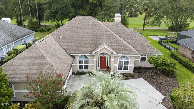 ranch-style home featuring a front yard