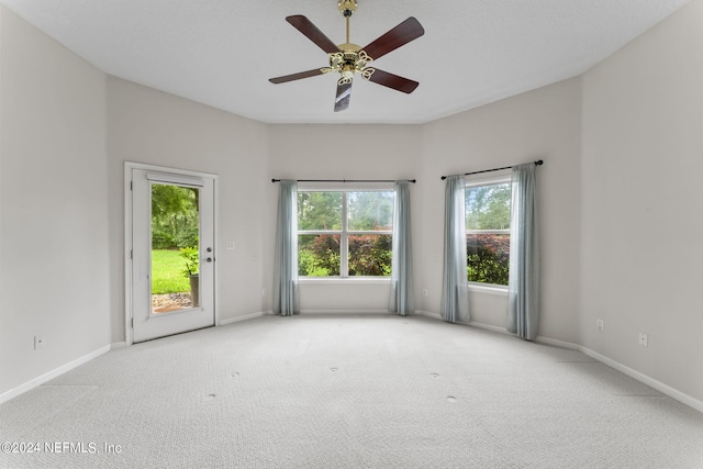 empty room featuring light carpet and ceiling fan