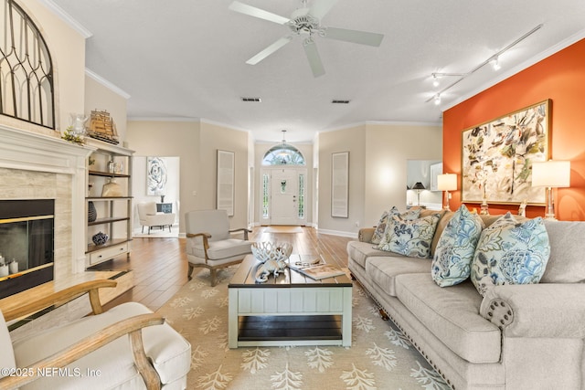 4039 Glenhurst Dr N, Jacksonville, FL 32224 - living room with wood finished floors, a high end fireplace, crown molding, track lighting, and ceiling fan