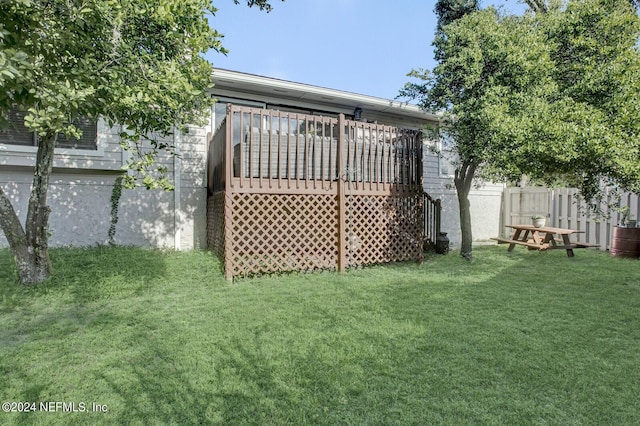 view of yard featuring fence and a wooden deck