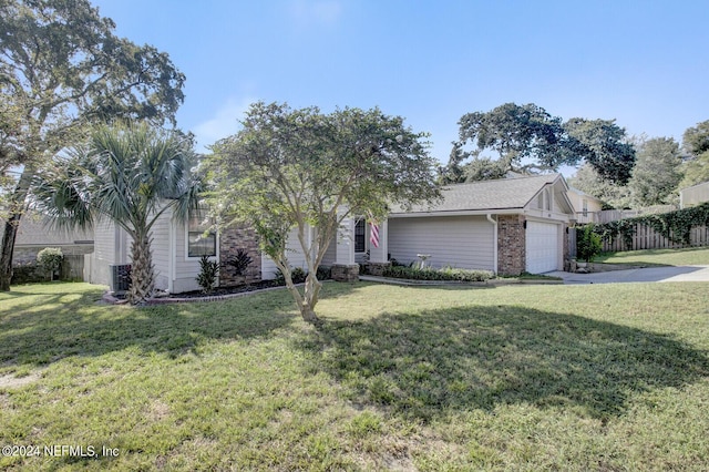 view of front of property featuring a garage, concrete driveway, a front yard, and fence