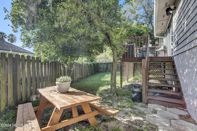 view of yard with a fenced backyard, stairs, and a deck