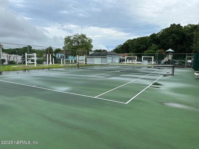 view of sport court featuring fence