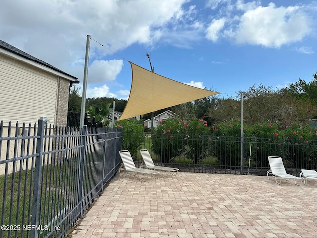 view of patio featuring fence