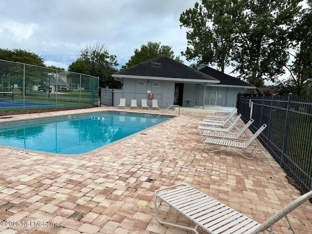 pool featuring fence and a patio