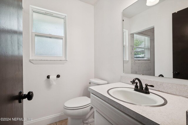 bathroom featuring vanity, toilet, and tile patterned floors